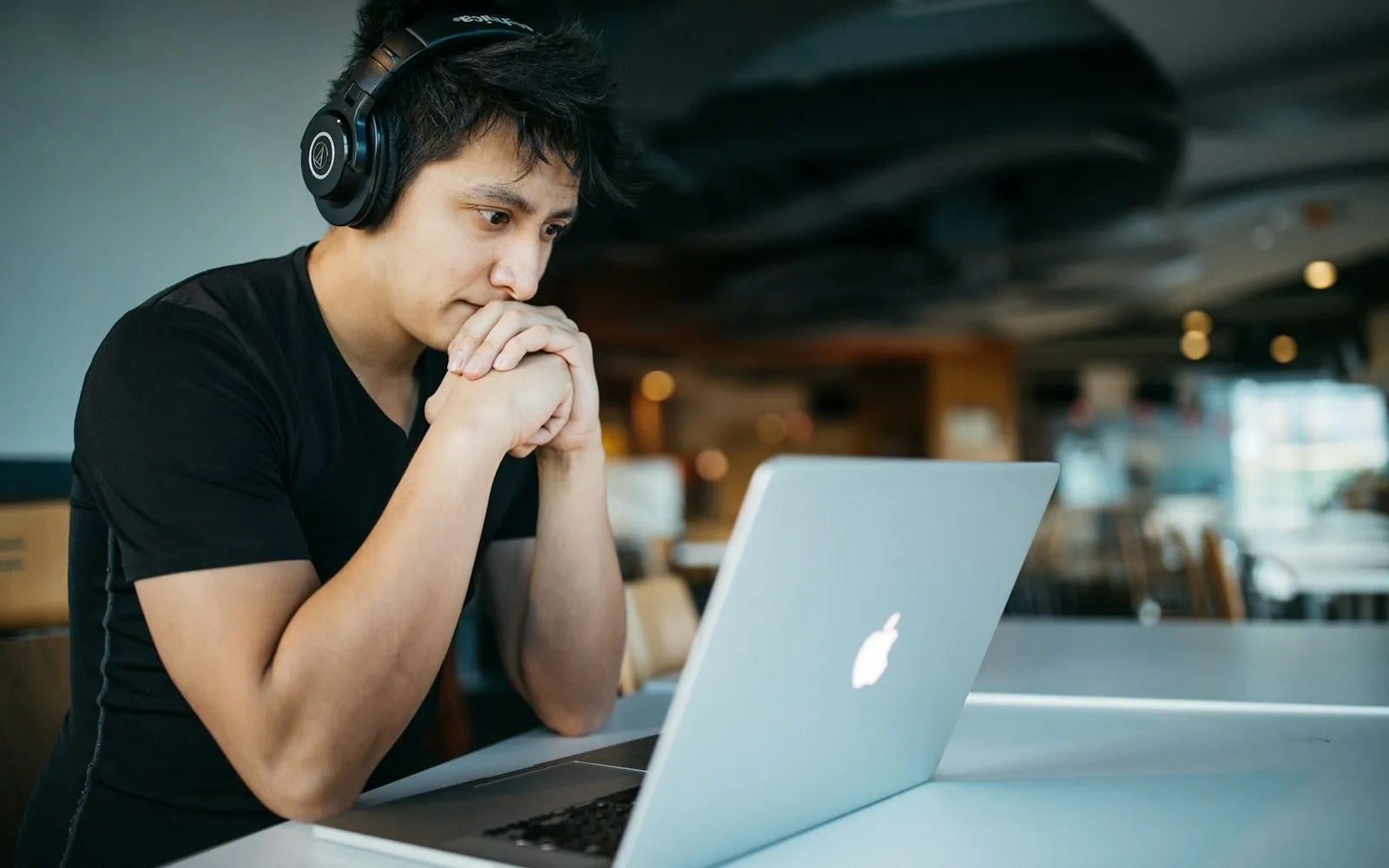 Laptop showing an online course with notebooks and a cup of coffee beside it