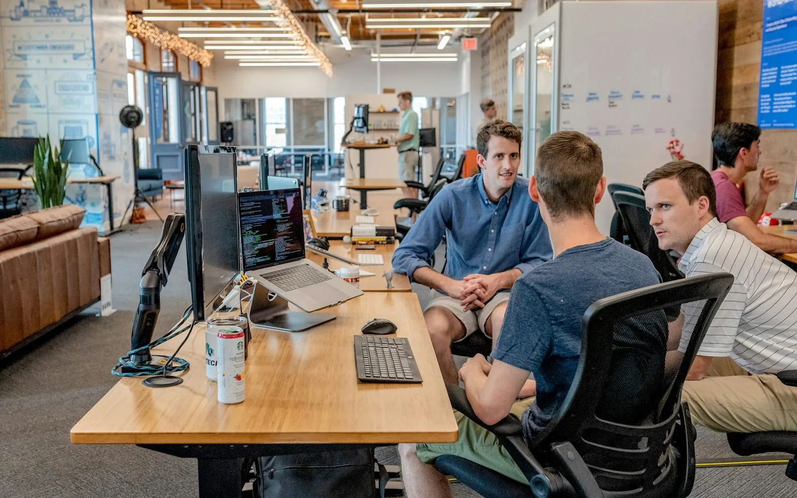 Two colleagues discussing compensation across a conference table